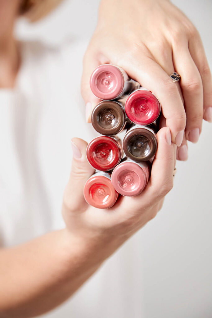 Pigments in bottles for tattoos and permanent makeup in woman hands closeup. Tattoo ink